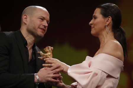 Nadav Lapid recieves Golden Bear for Best Film from president of the International Jury Juliette Binoche, during the awards ceremony at the 69th Berlinale International Film Festival in Berlin, Germany, February 16, 2019. REUTERS/Hannibal Hanschke