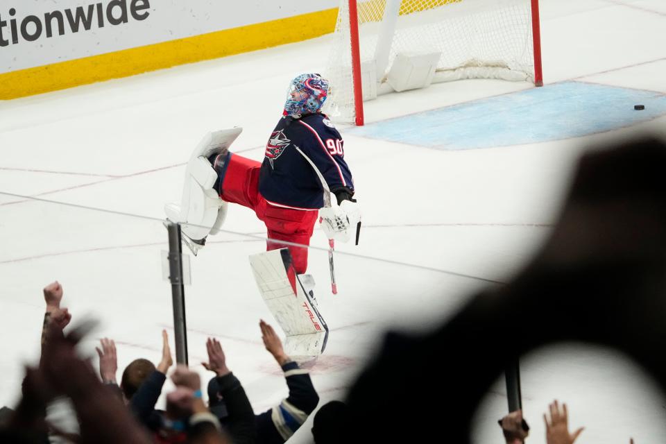 Jan 15, 2024; Columbus, Ohio, USA; Columbus Blue Jackets goaltender Elvis Merzlikins (90) celebrates following the shootout in the NHL hockey game against the Vancouver Canucks at Nationwide Arena. The Blue Jackets won 4-3.