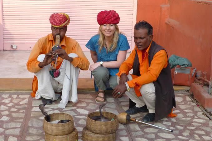 Angela Saurine with snake charmers in India. Photo: Supplied