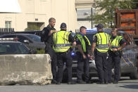 Police officers stand near barriers added to block access to downtown, Sept. 22, 2020 in Louisville. Officials in Louisville were preparing Tuesday for more protests and possible unrest as the public nervously awaits the state attorney general’s announcement about whether he will charge officers in Breonna Taylor’s shooting death. Taylor's shooting has been followed by months of protests in the city. (AP Photo/ Dylan Lovan)