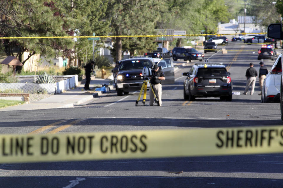 Investigators work along a residential street following a deadly shooting Monday, May 15, 2023, in Farmington, N.M. Authorities said an 18-year-old opened fire in the northwestern New Mexico community, killing multiple people and injuring others, before law enforcement fatally shot the suspect. (AP Photo/Susan Montoya Bryan)