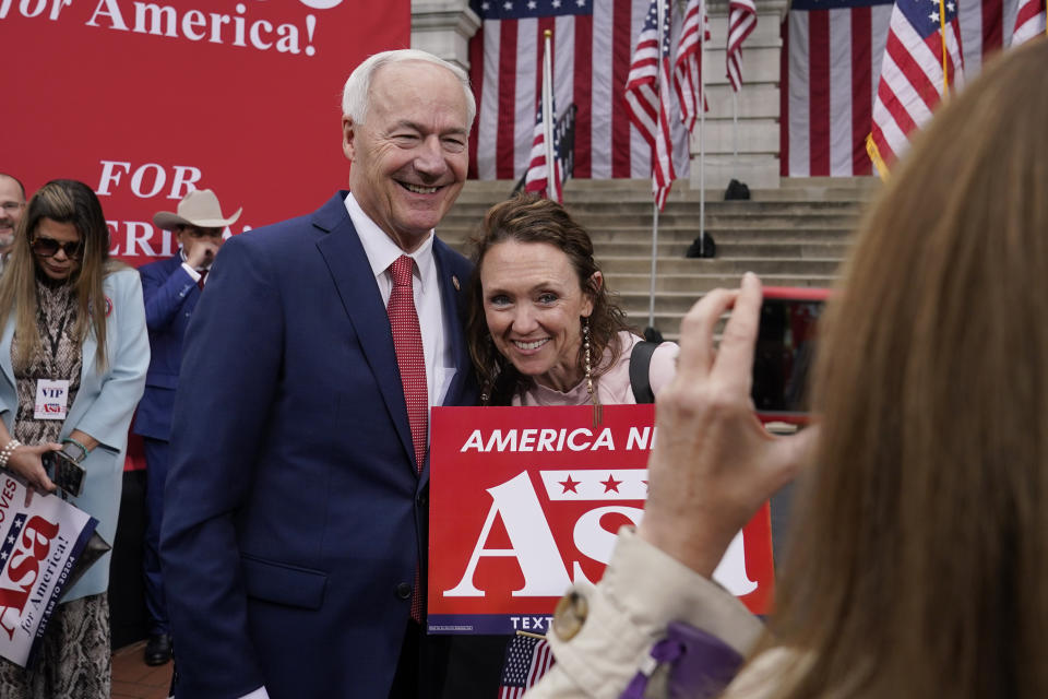 Former Arkansas Gov. Asa Hutchinson poses for a photo with supporter Leigh Fox, of Bella Vista, Ark., after formally announcing his Republican campaign for president, Wednesday, April 26, 2023, in Bentonville, Ark. (AP Photo/Sue Ogrocki)