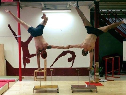 Insider's Sam Tabahriti practices a one-handed handstand with a partner.