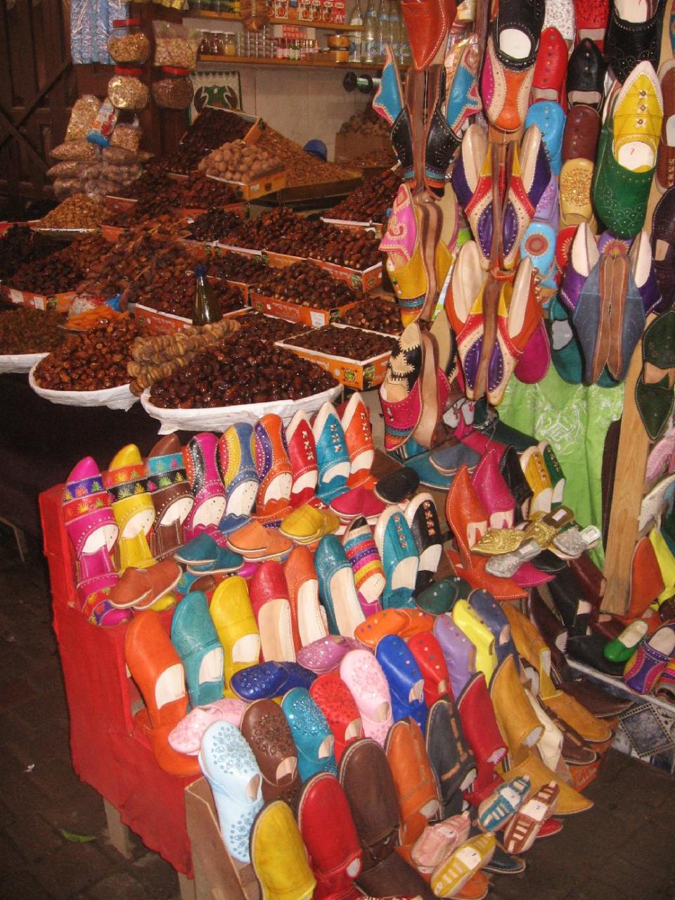 This January 2013 shows two traditional Moroccan products -- dates and leather slippers -- for sale in the souks inside Fez's medieval medina. Morocco's historic medinas are a haggling shopper's paradise. (AP Photo/Giovanna Dell'Orto)