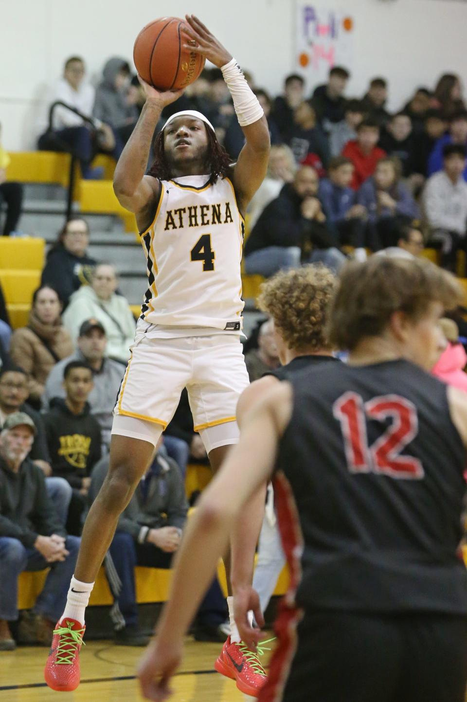 Athena's Zacarr Johnson puts up a three point shot in the first half.