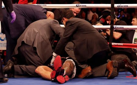 Jan 16, 2016; Brooklyn, NY, USA; Artur Szpilka is examined by trainers after being knocked out by Deontay Wilder during their heavyweight title boxing fight at Barclays Center. Wilder defeated Szpilka via ninth round knockout. Mandatory Credit: Adam Hunger-USA TODAY Sports