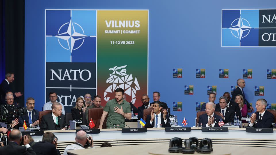 Ukrainian President Volodymyr Zelensky (standing, second left) is applauded by the Turkish, British and US leaders at a meeting of the NATO-Ukraine Council during a NATO summit in Vilnius on July 12, 2023. - Murat Kula/Anadolu Agency/Getty Images