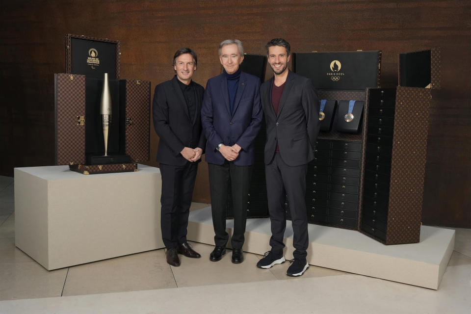 Pietro Beccari, Bernard Arnault and Tony Estanguet, president of Paris 2024, louis vuitton trunks, medals and torches paris olympics 2024