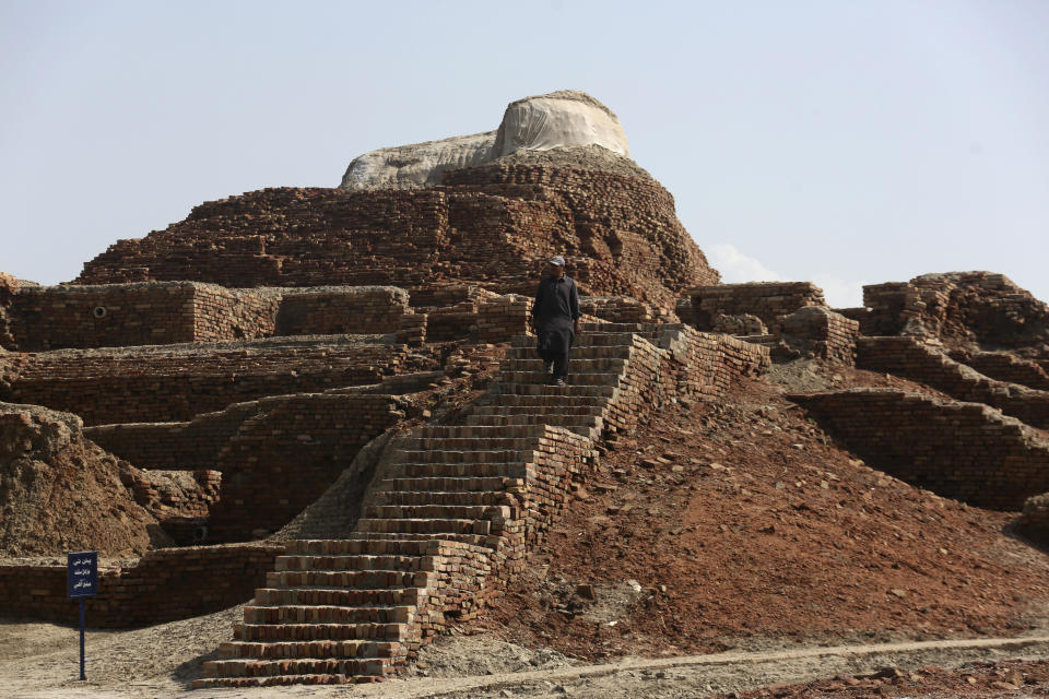 A man walks at Mohenjo-daro, a UNESCO World Heritage Site in Pakistan's southern Sindh province, after heavy rainfall in the region damaged some of the site's ruins, September 6, 2022. / Credit: Fareed Khan/AP