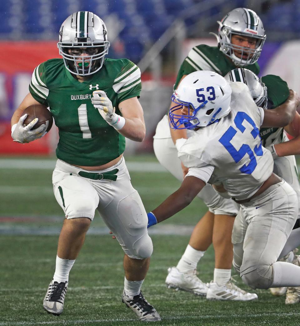 Dragons running back/captain Alex Barlow runs through a hole in Scituate's line. Duxbury High and Scituate High play the MIAA Division 4 State Championship at Gillette Stadium on Friday, Dec. 1, 2023.