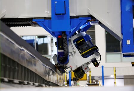 An electroimpact automated fiber placement machine, which lays down carbon fiber strips onto the 777X spar, seen during a media tour of the Boeing 777X at the Boeing Composite Wing Center in Everett