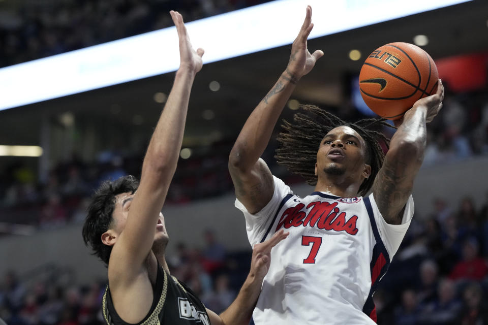 Mississippi guard Allen Flanigan (7) shoots past the defense of Bryant guard Rafael Pinzon, left, during the first half of an NCAA college basketball game, Sunday, Dec. 31, 2023, in Oxford, Miss. (AP Photo/Rogelio V. Solis)