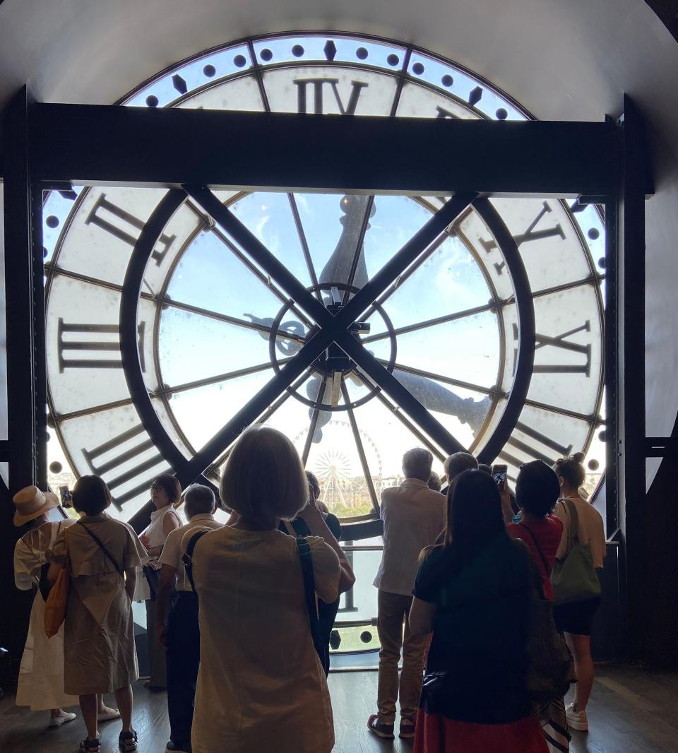 People admire a massive clock at the Musée d'Orsay in Paris.