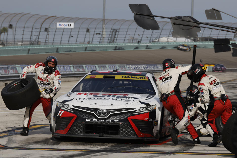 Denny Hamlin (11) makes a pit stop during the NASCAR Cup Series auto race at Homestead-Miami Speedway, Sunday, Oct. 22, 2023 in Homestead, Fla. (AP Photo/Terry Renna)