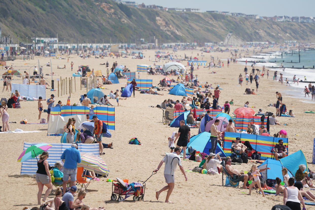 People on Boscombe beach, with the bank holiday weekend expected to bring blue skies and widespread sunshine. Picture date: Sunday May 30, 2021.