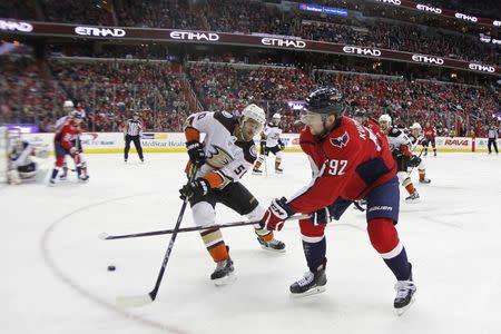 Dec 16, 2017; Washington, DC, USA; Washington Capitals center Evgeny Kuznetsov (92) shoots the puck on Anaheim Ducks goalie John Gibson (36) as Ducks center Antoine Vermette (50) defends in the third period at Capital One Arena. The Capitals won 3-2 in overtime. Mandatory Credit: Geoff Burke-USA TODAY Sports