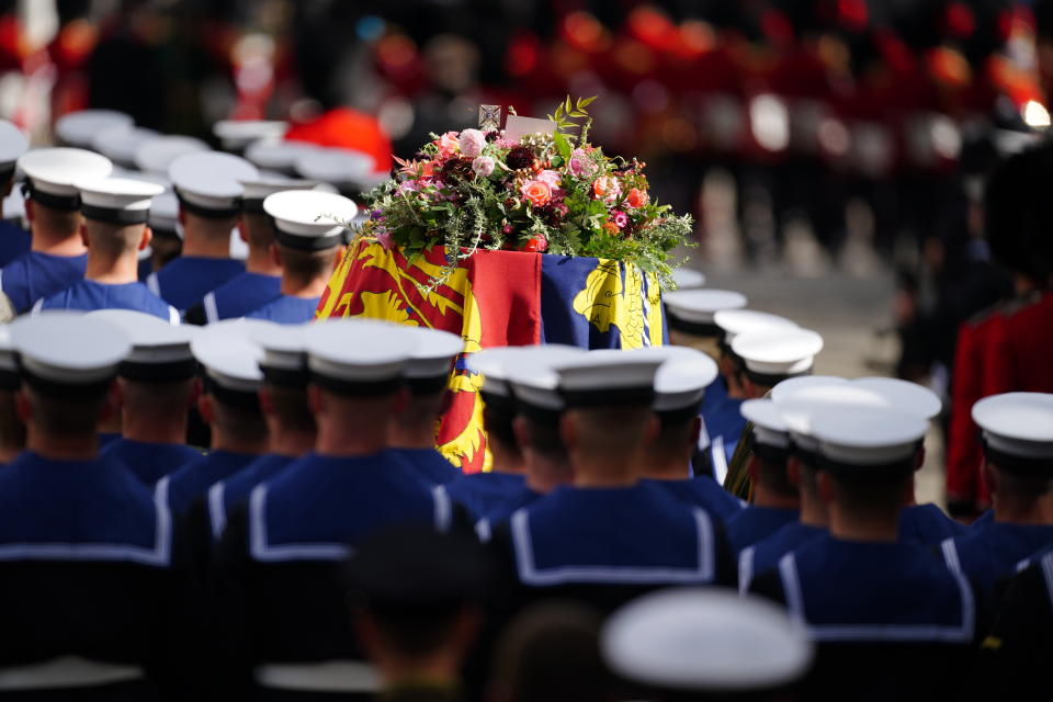 The State Gun Carriage carries the coffin of Queen Elizabeth II, draped in the Royal Standard with the Imperial State Crown and the Sovereign's orb and sceptre with a message from King Charles III, in the Ceremonial Procession following her State Funeral at Westminster Abbey, London. Picture date: Monday September 19, 2022. (Photo by Peter Byrne/PA Images via Getty Images)