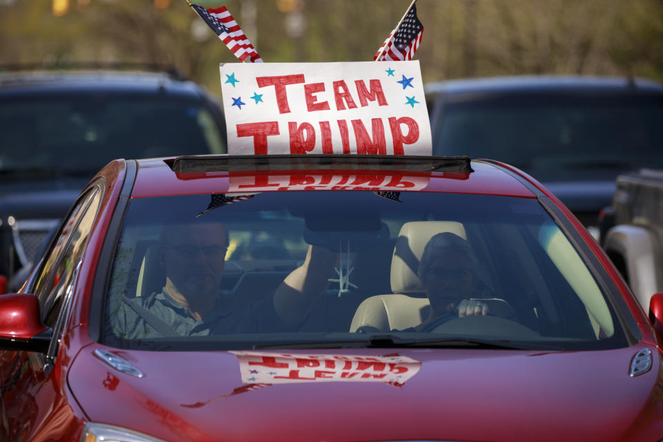 Trump supporters in a car join a protest while driving on the street in Indianapolis.