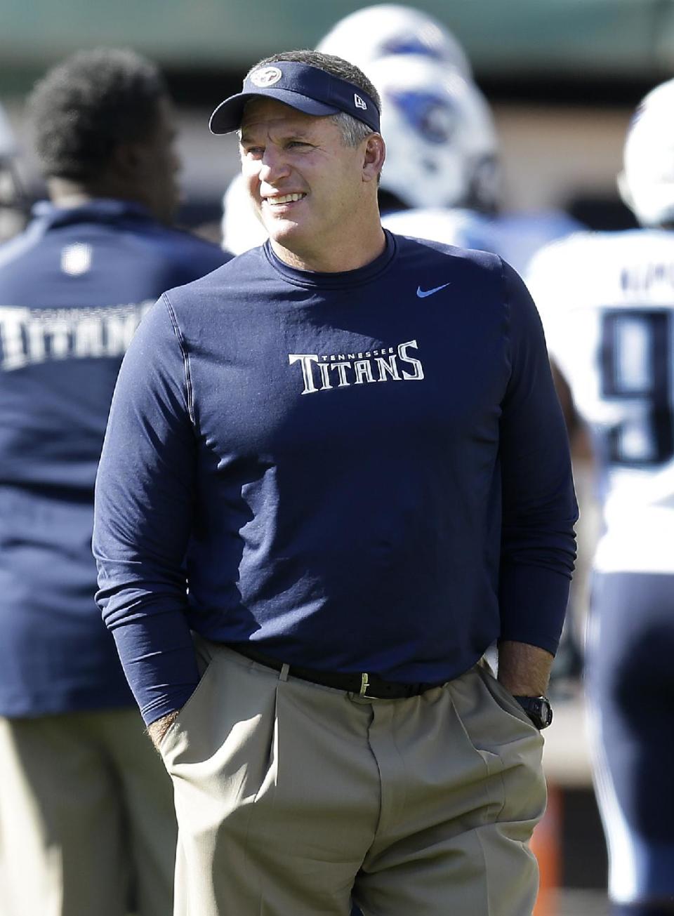 FILE - In this Nov. 24, 2013, file photo, Tennessee Titans head coach Mike Munchak watches as players warm up before an NFL football game against the Oakland Raiders in Oakland, Calif. person familiar with the decision say Titans President Tommy Smith has fired Munchak after three seasons as his head coach and 31 years combined with this franchise as a player and coach. The person spoke to The Associated Press on Saturday, Jan. 4, 2014, on the condition of anonymity because the Titans have not made an official announcement. (AP Photo/Ben Margot, File)