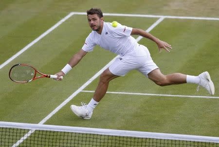 Stanislas Wawrinka of Switzerland hits a return during his men's singles tennis match against Feliciano Lopez of Spain at the Wimbledon Tennis Championships, in London July 1, 2014. REUTERS/Suzanne Plunkett