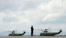 A Secret Service agent keeps watch as Marine One prepares for liftoff, to take U.S. President Donald Trump and his staff to nearby Camp David to meet with the National Security Council to try to agree on a strategy for Afghanistan, in Hagerstown, Maryland, U.S., August 18, 2017. REUTERS/Kevin Lamarque