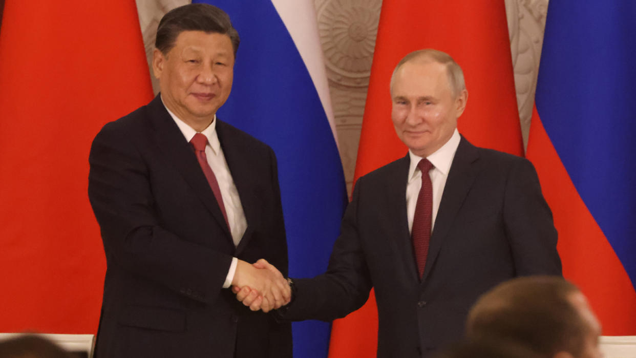 Chinese President Xi Jinping and Russian President Vladimir Putin shake hands during a signing ceremony at the Grand Kremlin Palace, on March 21 in Moscow. 
