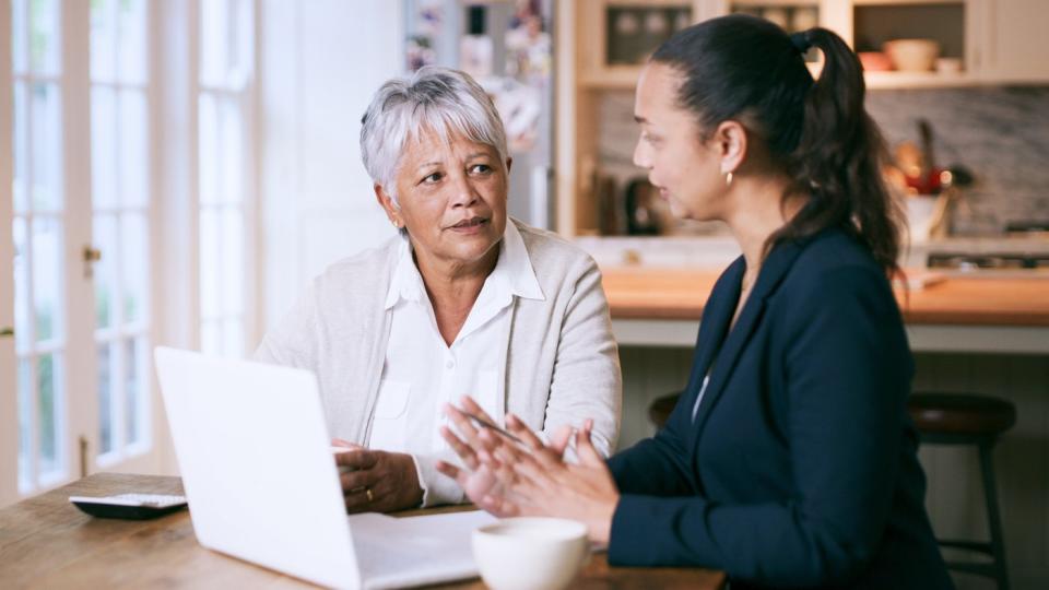 Two adults looking at laptop together.