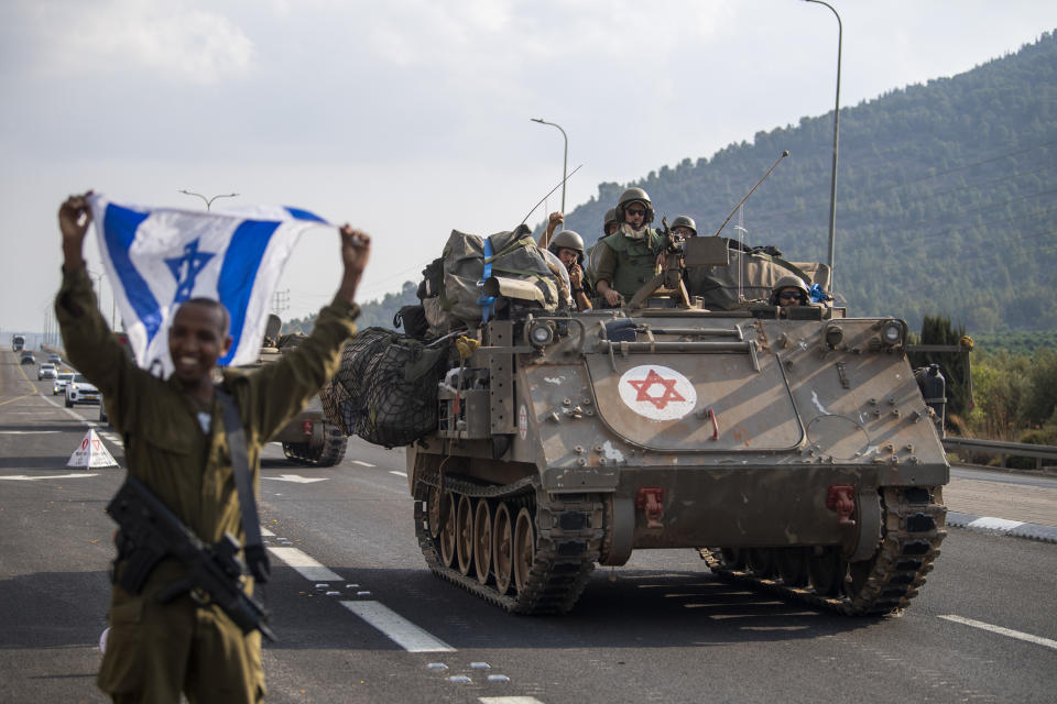 Israeli armored carriers head to the border with Lebanon on Tuesday, Oct. 10, 2023. (AP Photo/Gil Eliyahu)