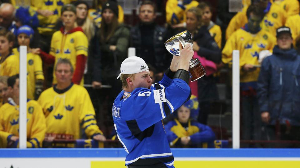 Swedish fans watch Finland's Rasmus Ristolainen celebrates with the trophy after defeating Sweden in overtime of their IIHF World Junior Championship gold medal ice hockey game in Malmo, Sweden, January 5, 2014. REUTERS/Alexander Demianchuk (SWEDEN - Tags: SPORT ICE HOCKEY)