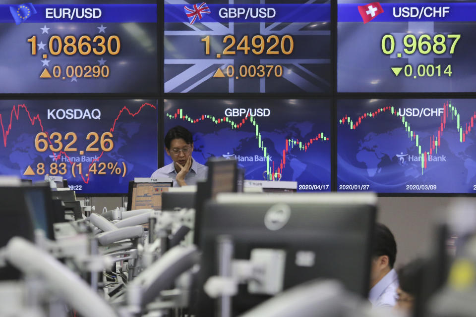 A currency trader watches monitors at the foreign exchange dealing room of the KEB Hana Bank headquarters in Seoul, South Korea, Friday, April 17, 2020. Shares have advanced in Asia after China's economic growth data, while bleak, was better than expected. (AP Photo/Ahn Young-joon)