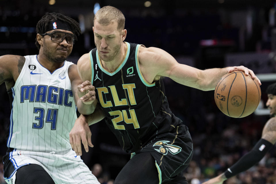 Orlando Magic center Wendell Carter Jr. (34) guards Charlotte Hornets center Mason Plumlee (24) during the first half of an NBA basketball game in Charlotte, N.C., Sunday, Feb. 5, 2023. (AP Photo/Jacob Kupferman)