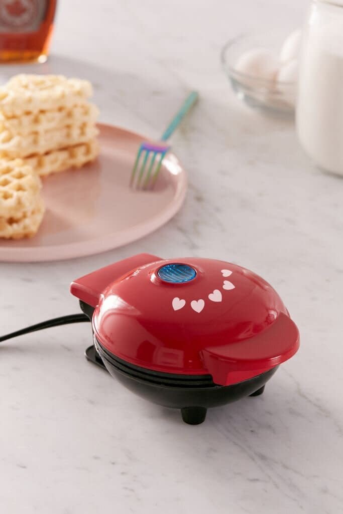 Batter up &mdash; this mini waffle maker can whip up heart-shaped waffles that they'll love. The waffle maker is small enough to not take up too much space and comes with non-stick coating so cleaning up doesn't become a chore. <a href="https://fave.co/2JzGoUr" target="_blank" rel="noopener noreferrer">Find it for $18 at Urban Outfitters</a>.