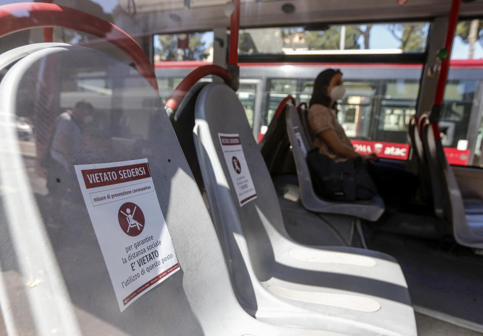 Signs warn against sitting on some seats on a bus in Rome on Monday.