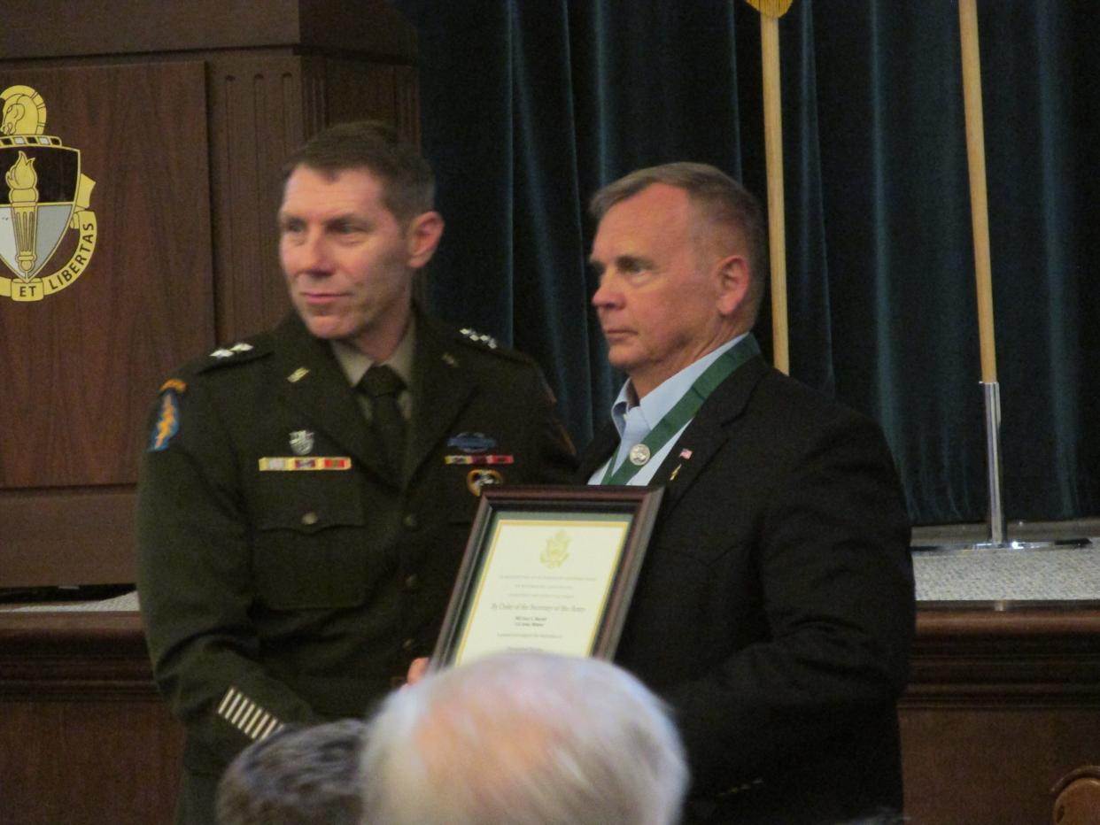 Maj. Gen Patrick Roberson, left, recognizes retired Maj. Gen. Gary Harrell as a Distinguished Member of the Special Forces Regiment during a ceremony Tuesday, May 24, 2022, at Fort Bragg.