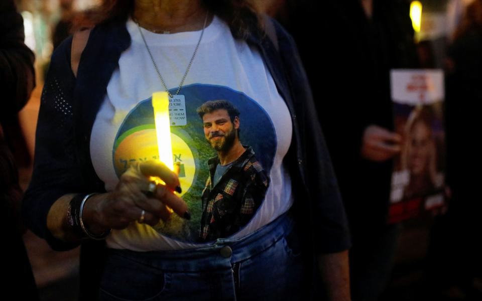 Family members of hostages kidnapped by Hamas gather to light candles to mark the first night of Hanukkah