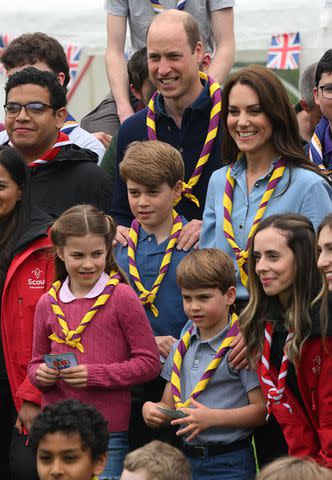 <p>Daniel Leal - WPA Pool/Getty</p> Catherine, Princess of Wales, Prince William, Prince of Wales, Prince George of Wales, Prince Louis of Wales and Princess Charlotte of Wales pose for a group pictures with volunteers who are taking part in the Big Help Out, during a visit to the 3rd Upton Scouts Hut in Slough on May 8, 2023 in London, England