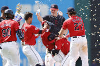 Cleveland Guardians' Brayan Rocchio is mobbed by teammates after hitting the game-winning RBI single off Detroit Tigers pitcher Alex Lange in the 10th inning of a baseball game, Wednesday, May 8, 2024, in Cleveland. (AP Photo/Ron Schwane)