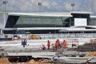Labourers work at Manaus airport in Manaus June 2, 2014. REUTERS/Bruno Kelly