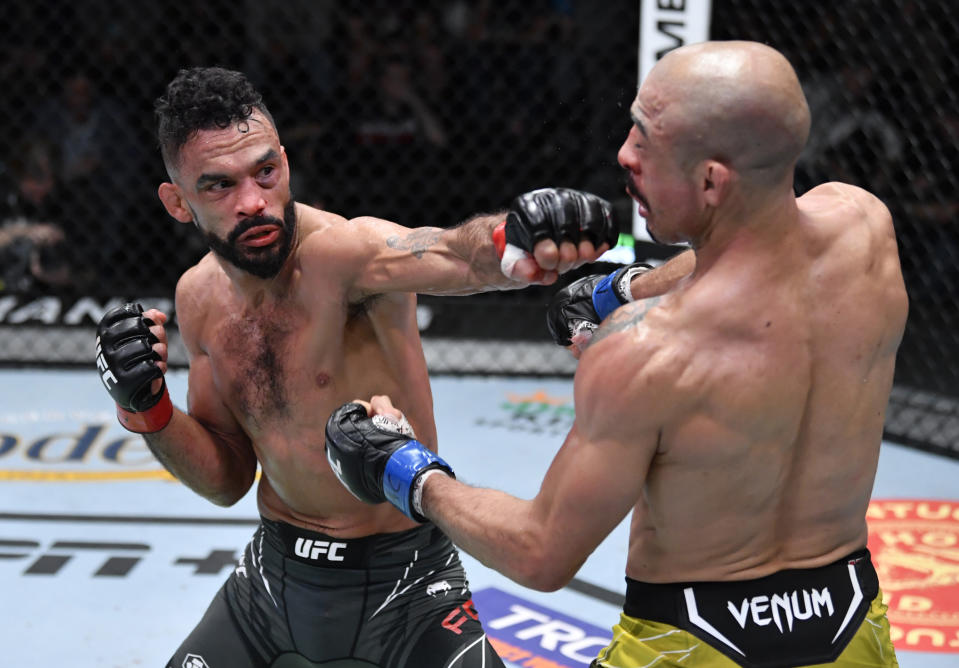 LAS VEGAS, NEVADA - DECEMBER 04: (L-R) Rob Font punches Jose Aldo of Brazil in their bantamweight fight during the UFC Fight Night event at UFC APEX on December 04, 2021 in Las Vegas, Nevada. (Photo by Jeff Bottari/Zuffa LLC)