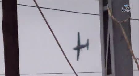 A still image taken from a video posted on a social media website shows what is said to be an Iraqi Air Force plane flying overheard in Hawija, northwest of Kirkuk, Iraq March 16, 2016. Social Media Website via Reuters TV