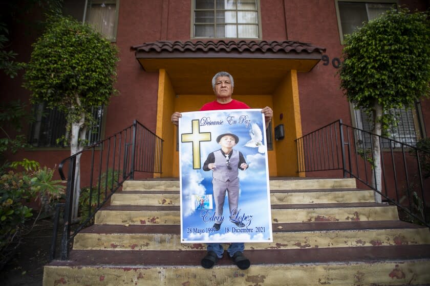 Margarito Lopez holds a memorial poster where his son, Margarito Lopez 22, whowas shot and killed by the LAPD