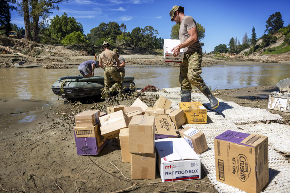 New Zealand defense force personnel deliver supplies to stranded families following Cyclone Gabrielle, in Rissington, New Zealand, Sunday, Feb. 19, 2023. Cyclone Gabrielle struck the country's north on Feb. 13 and the level of damage has been compared to Cyclone Bola in 1988. That storm was the most destructive on record to hit the nation of 5 million people. (Mike Scott/NZ Herald via AP)
