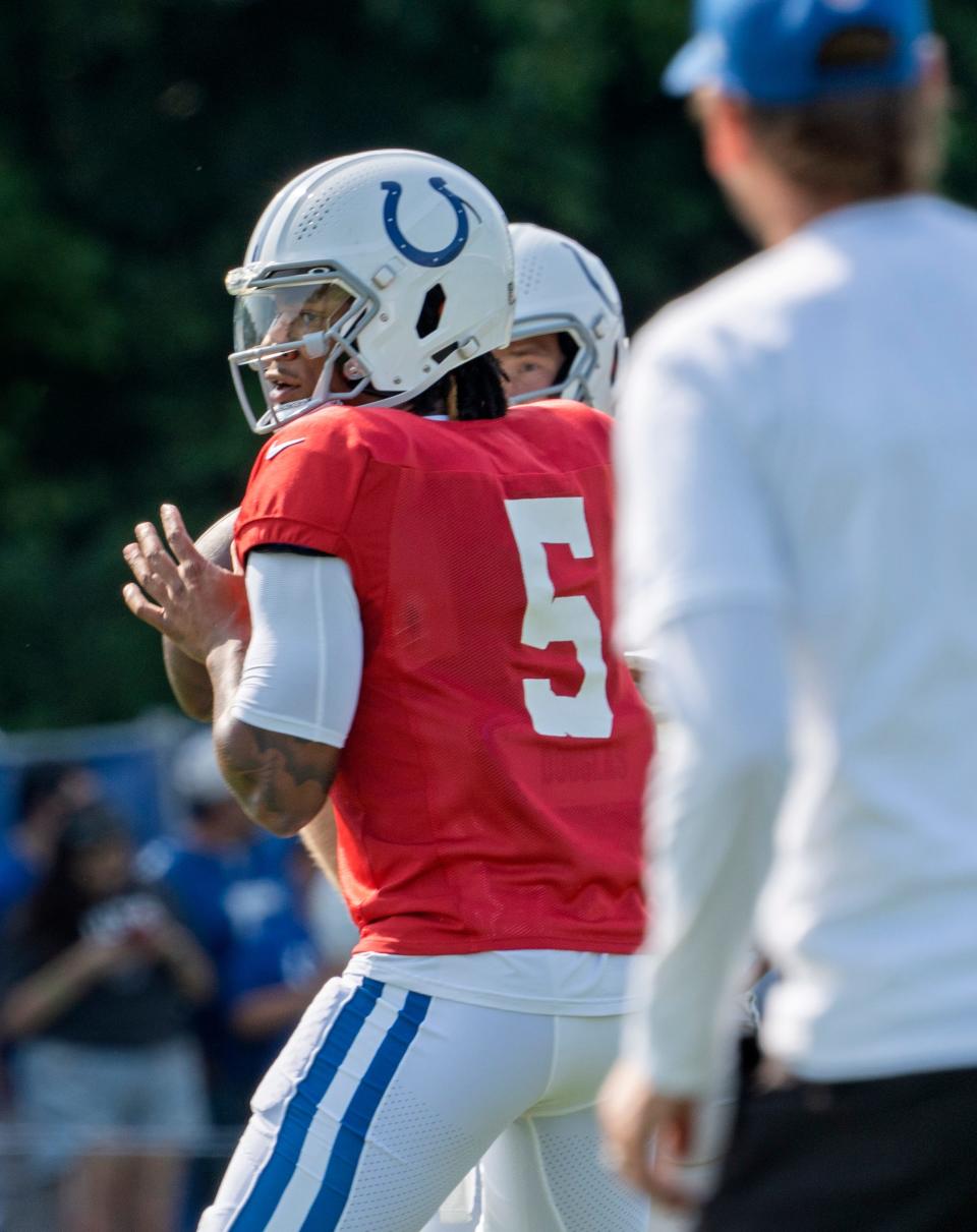 Indianapolis Colts quarterback Anthony Richardson (5) runs passing drills as Indianapolis Colts Head Coach Shane Steichen, right, watches during Colts Camp practice at Grand Park, Tuesday, Aug. 1, 2023 in Westfield.