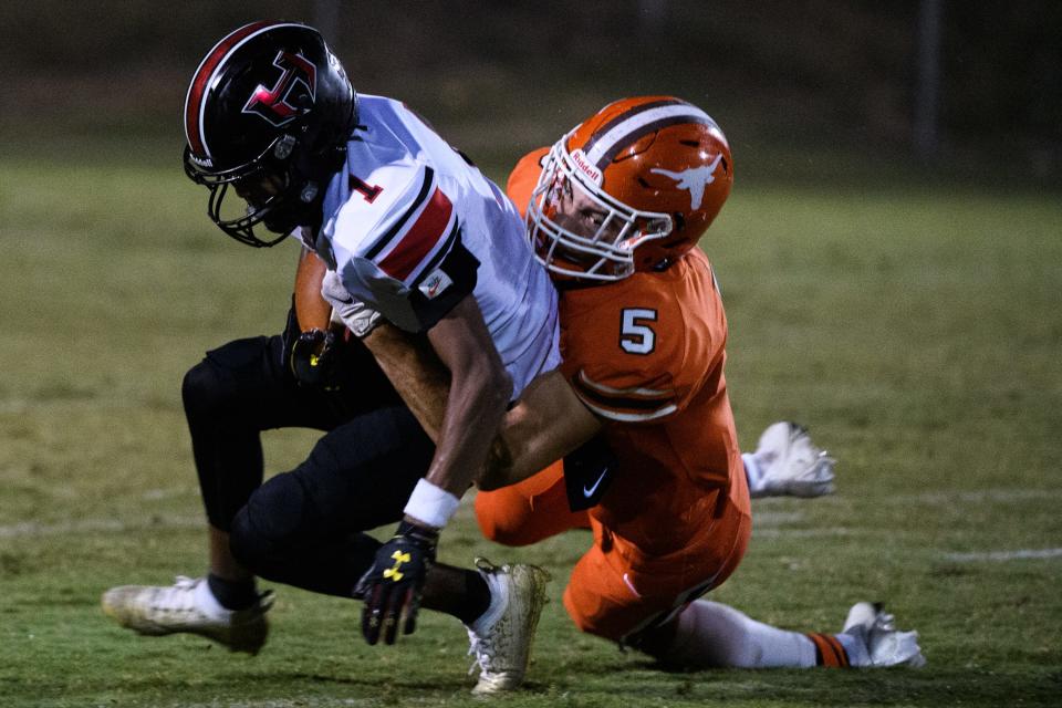 Hillcrest wide receiver Jaylen Neal (1) is tackled by Mauldin defensive back/wide receiver Jaedyn Lukus (5) during their game Friday, Oct. 1, 2021.