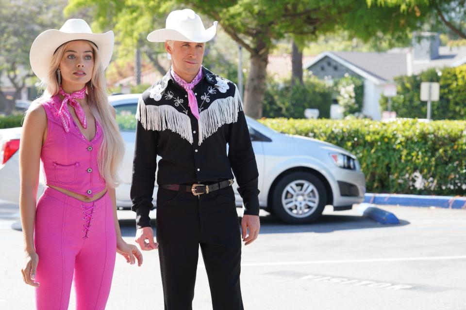Margot Robbie and Ryan Gosling dressed in western outfits as Barbie and Ken in "Barbie."