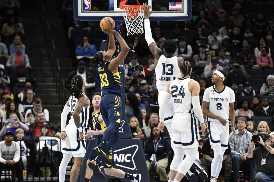 Indiana Pacers center Myles Turner (33) shoots against Memphis Grizzlies forward Jaren Jackson Jr. (13) in the first half of an NBA basketball game Sunday, Jan. 29, 2023, in Memphis, Tenn. (AP Photo/Brandon Dill)