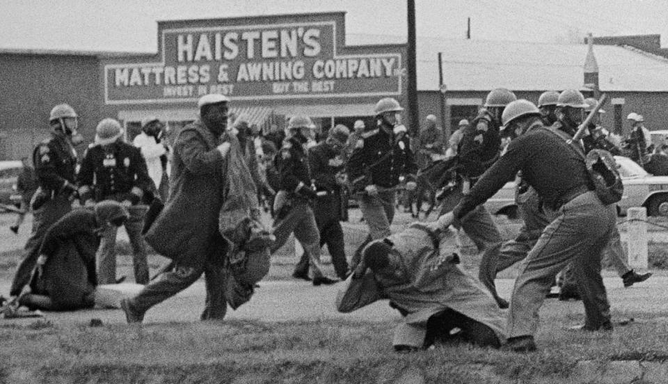 In the foreground of this photo from Selma’s “Bloody Sunday,” John Lewis  is being beaten by a state trooper. Lewis  suffered a fractured skull.  