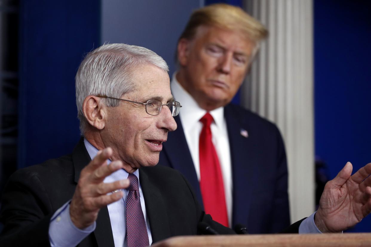 President Donald Trump watches as Dr. Anthony Fauci, director of the National Institute of Allergy and Infectious Diseases, speaks about the coronavirus in the James Brady Press Briefing Room of the White House, April 22, 2020, in Washington. Fauci, the nation's top infectious disease expert who became a household name, and the subject of partisan attacks, during the COVID-19 pandemic, announced Monday he will depart the federal government in December after more than five decades of service.  (AP Photo/Alex Brandon, File)