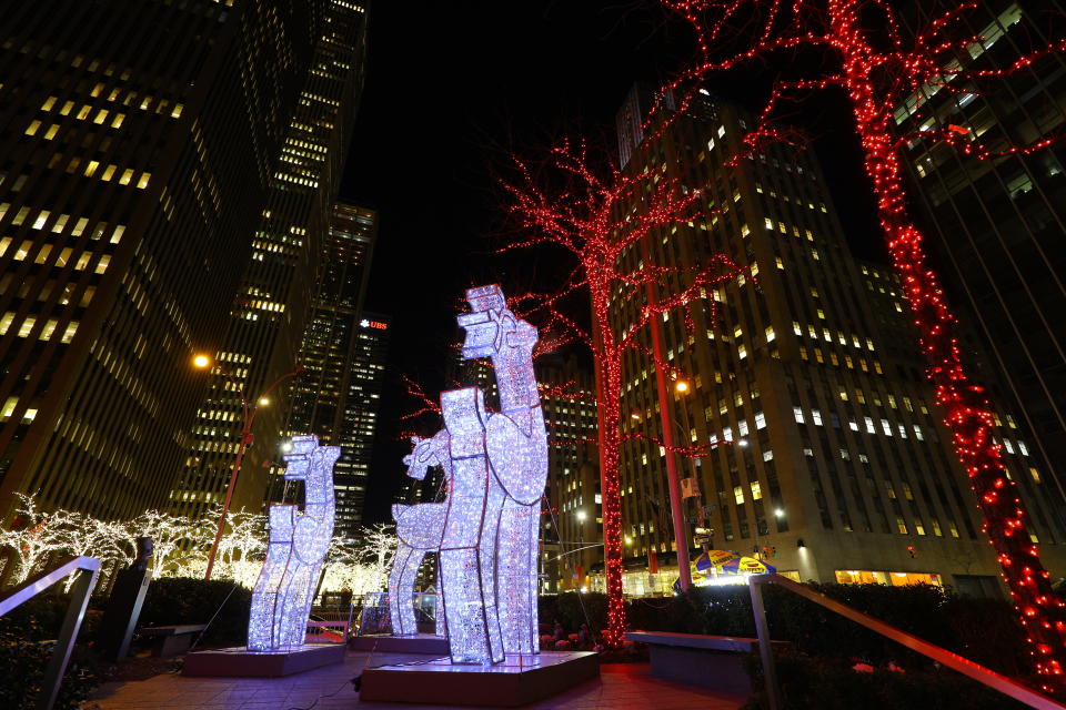 Reindeer made of lights stand tall outside an office building on Sixth Avenue. (Photo: Gordon Donovan/Yahoo News)