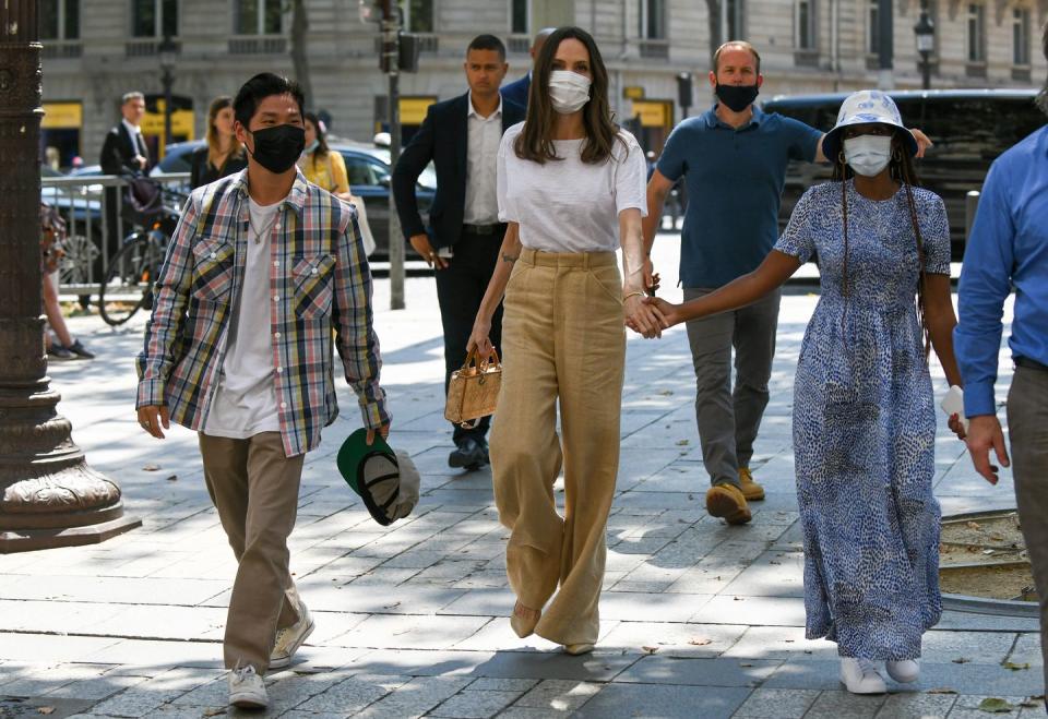 <p>Strolling down the Avenue des Champs-Élysées in Paris in 2021 with her son Pax and daughter Zahara. </p>